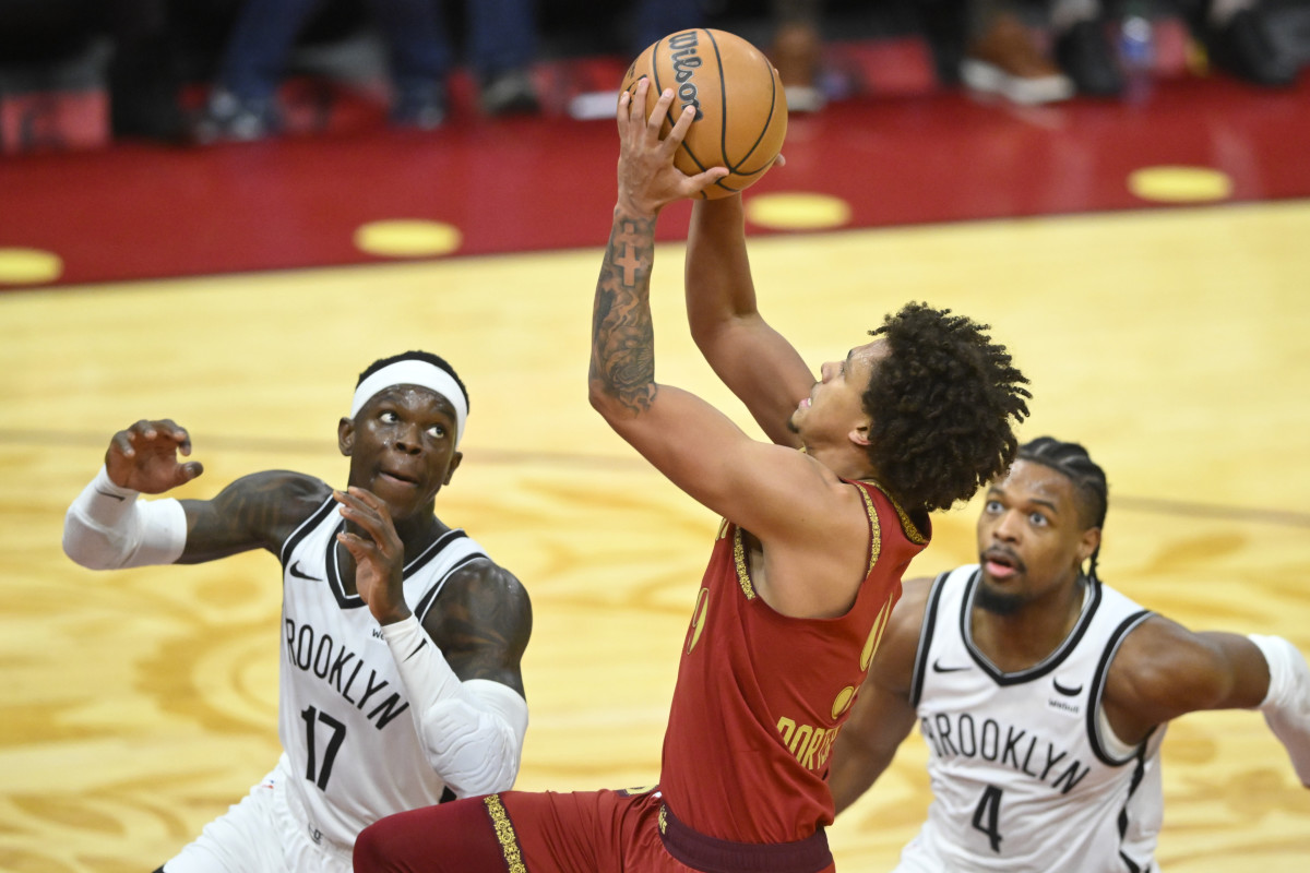 Mar 10, 2024; Cleveland, Ohio, USA; Cleveland Cavaliers guard Craig Porter Jr. (9) drives to the basket between Brooklyn Nets guard Dennis Schroder (17) and guard Dennis Smith Jr. (4) in the third quarter at Rocket Mortgage FieldHouse.